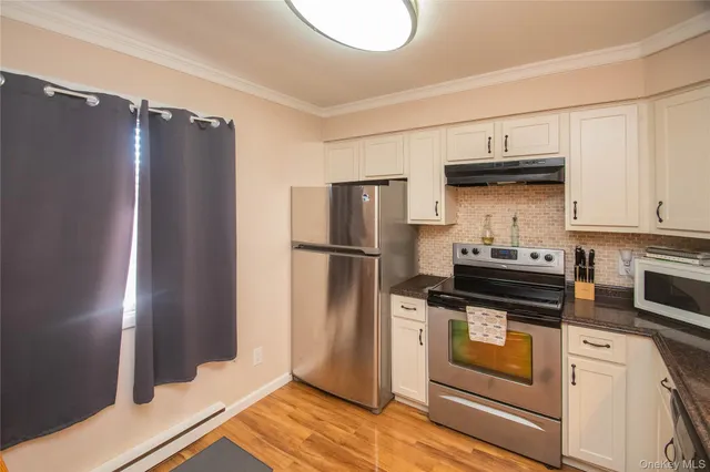 a kitchen with stainless steel appliances granite countertop a refrigerator sink and stove