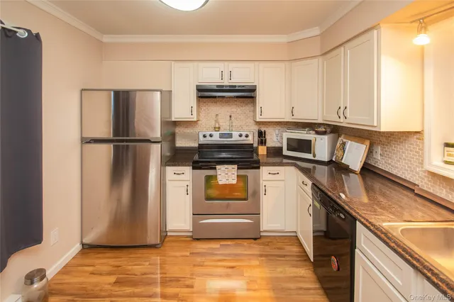 a kitchen with a stove refrigerator and cabinets