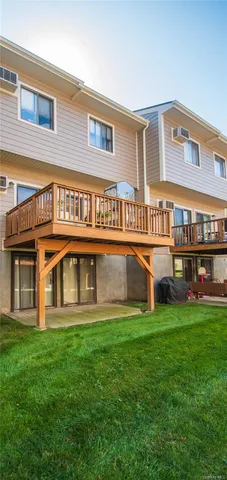 a view of a house with a yard and sitting area