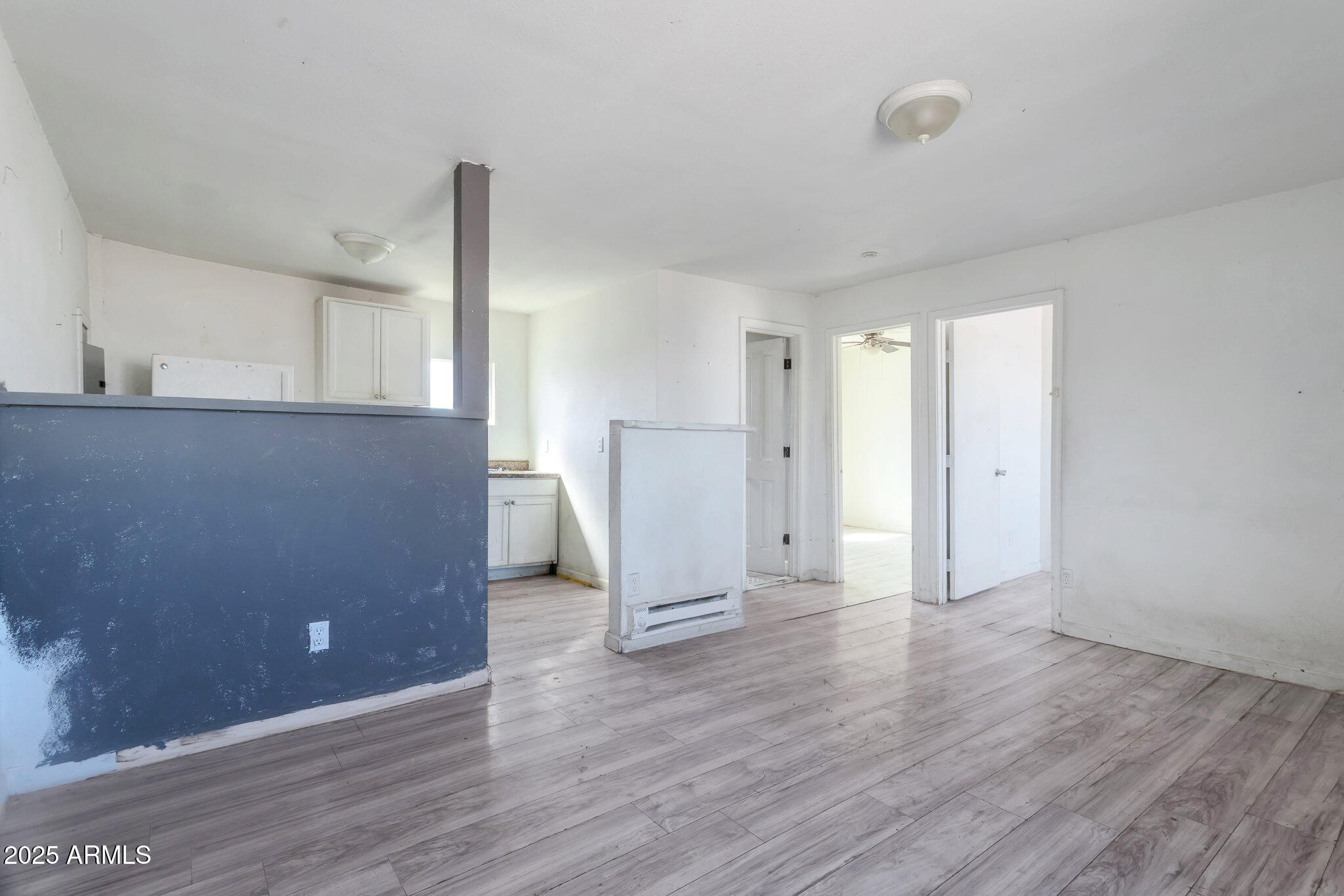 313 West Jones Avenue Phoenix, AZ 85041 - Photo 17 of 28 a view of a livingroom with wooden floor and a ceiling fan