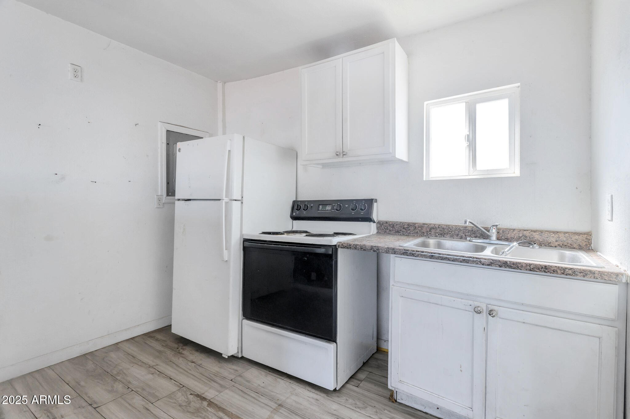 313 West Jones Avenue Phoenix, AZ 85041 - Photo 19 of 28 a kitchen with a sink and a refrigerator