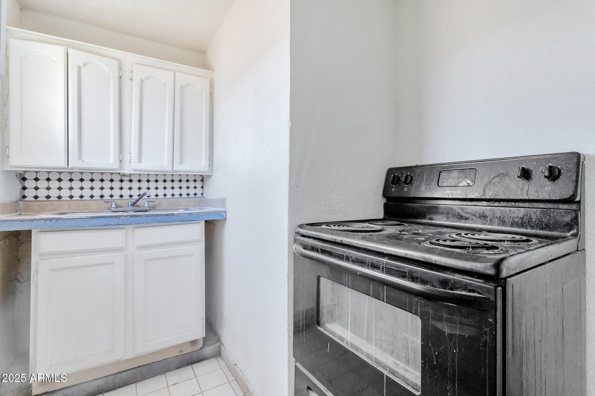 313 West Jones Avenue Phoenix, AZ 85041 - Photo 24 of 28 a stove top oven sitting inside of a kitchen