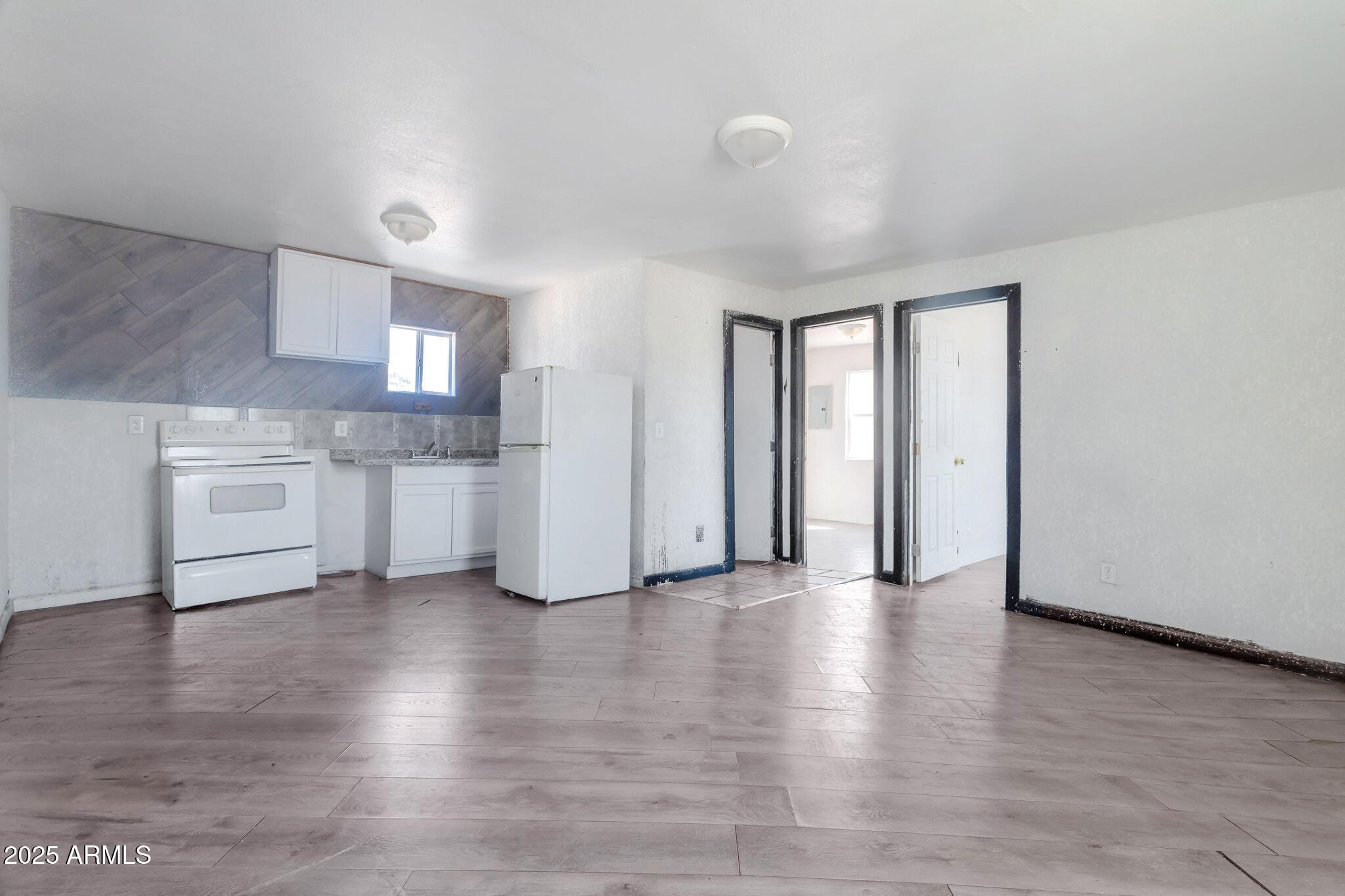 313 West Jones Avenue Phoenix, AZ 85041 - Photo 8 of 28 a view of a kitchen with a sink and dishwasher wooden floor