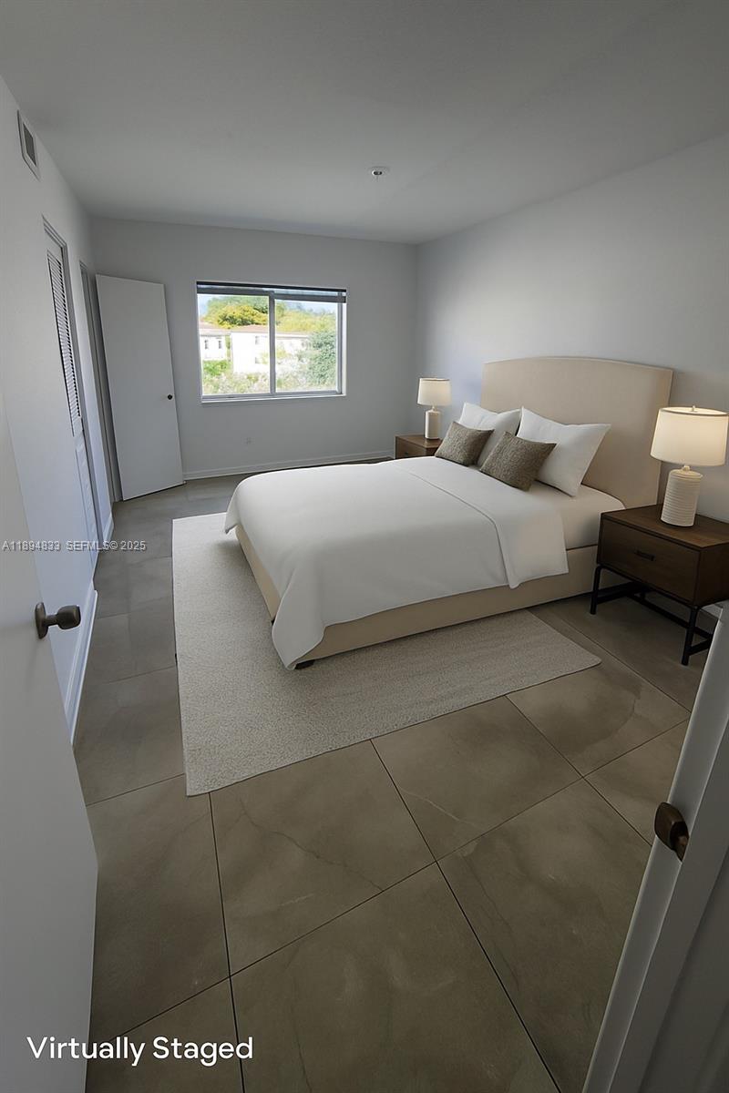 438 Northwest 84th Terrace, Unit 438 Miami, FL 33150 - Photo 4 of 20 a bedroom with a bed and a large window