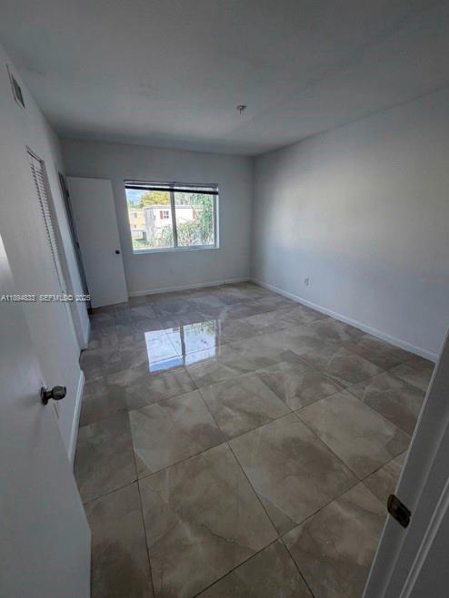 438 Northwest 84th Terrace, Unit 438 Miami, FL 33150 - Photo 5 of 20 an empty room with windows