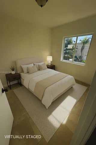 a bedroom with a bed and wall painting