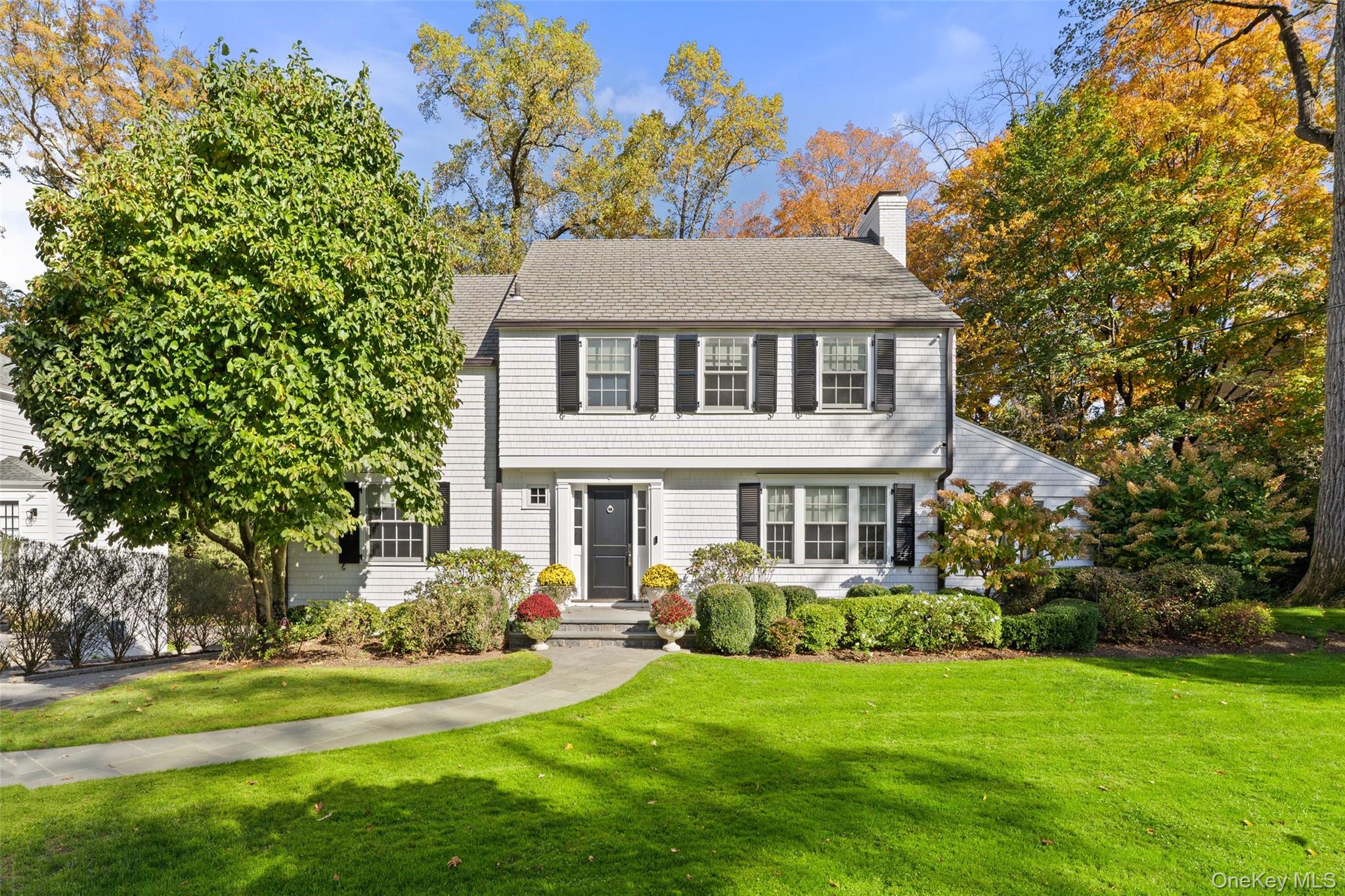 9 Broadmoor Road Scarsdale, NY 10583 - Photo 1 of 1 a front view of a house with a garden