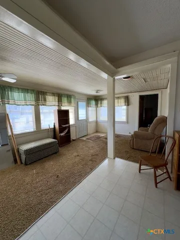 a living room with stainless steel appliances kitchen island granite countertop furniture and a kitchen view