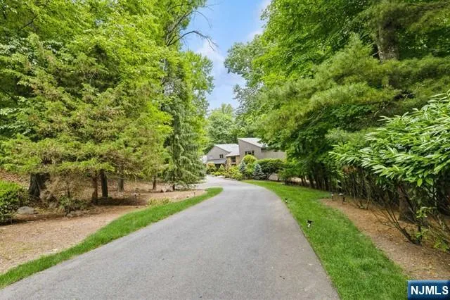 a view of a hallway with wooden floor and windows