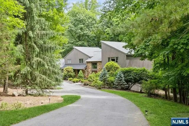 a view of entryway and hall with wooden floor and a kitchen view