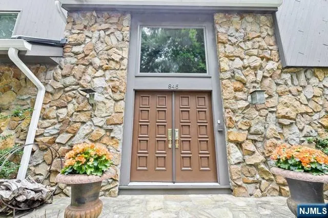 a living room with furniture wooden floor and a large window