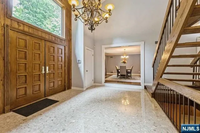 a living room with furniture a rug and a large window
