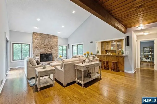 a living room with furniture large window and a flat screen tv