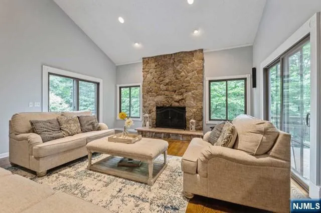 a dining room with furniture a chandelier and wooden floor