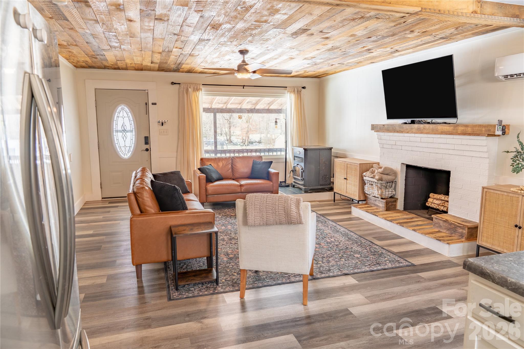 8573 Cruso Road Canton, NC 28716 - Photo 4 of 15 a living room with furniture a fireplace and a flat screen tv