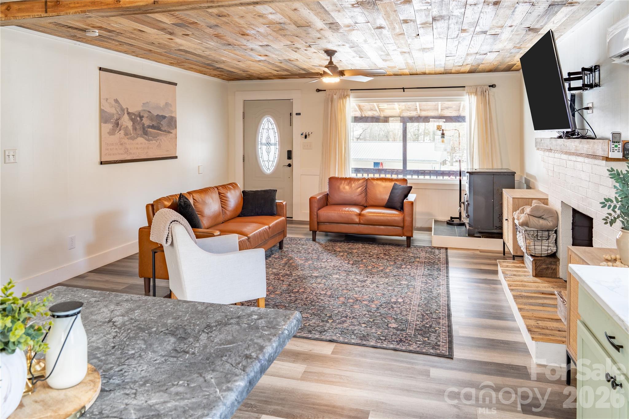 8573 Cruso Road Canton, NC 28716 - Photo 5 of 15 a living room with furniture a fireplace and a flat screen tv