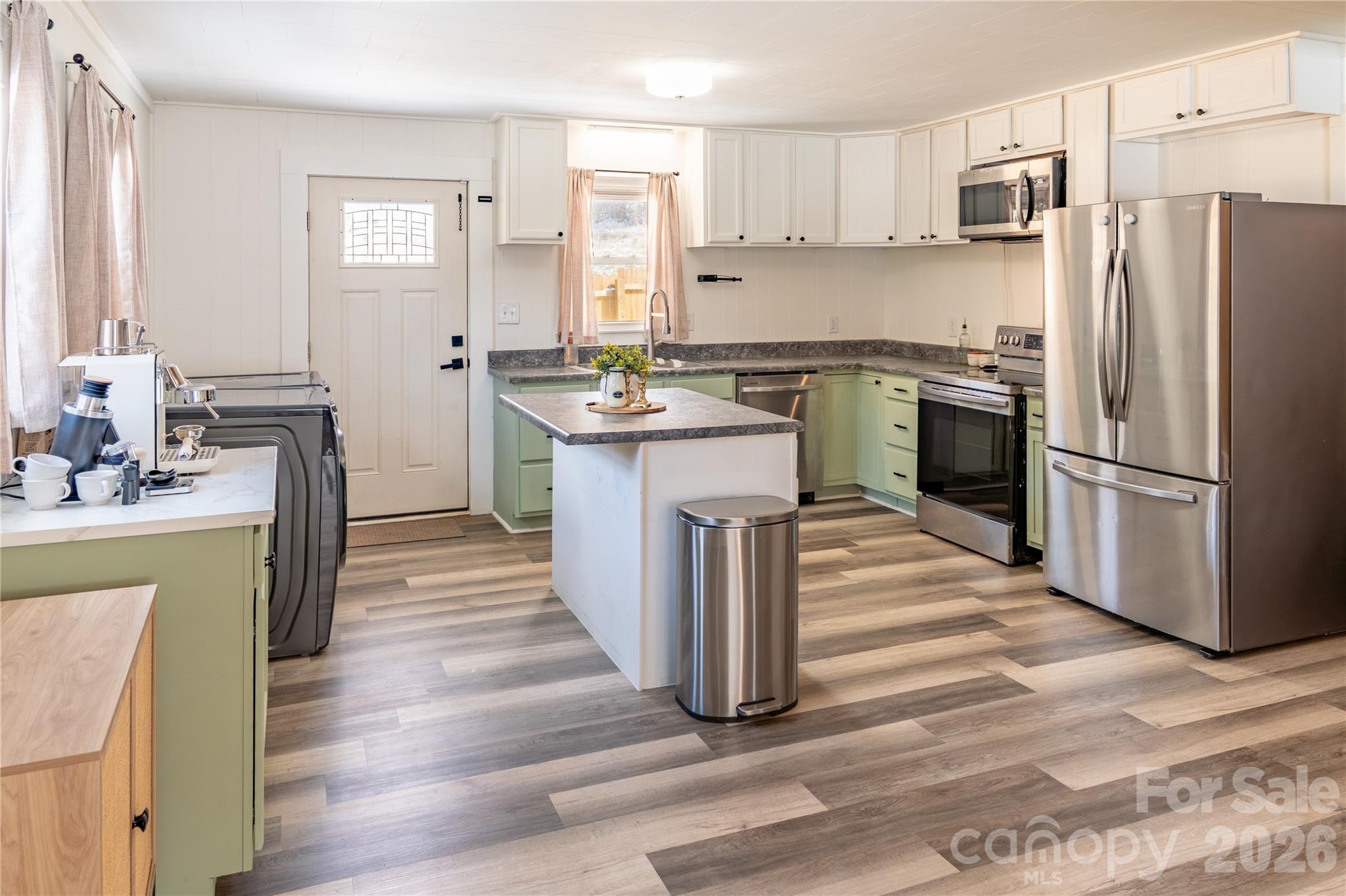 8573 Cruso Road Canton, NC 28716 - Photo 6 of 15 a kitchen with kitchen island a sink a counter top space stainless steel appliances and cabinets