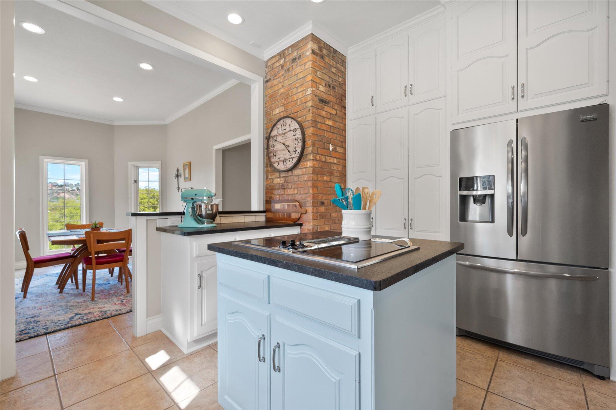 67 South Lake Shore Drive Ransom Canyon, TX 79366 - Photo 17 of 52 a kitchen with stainless steel appliances granite countertop a sink and a refrigerator