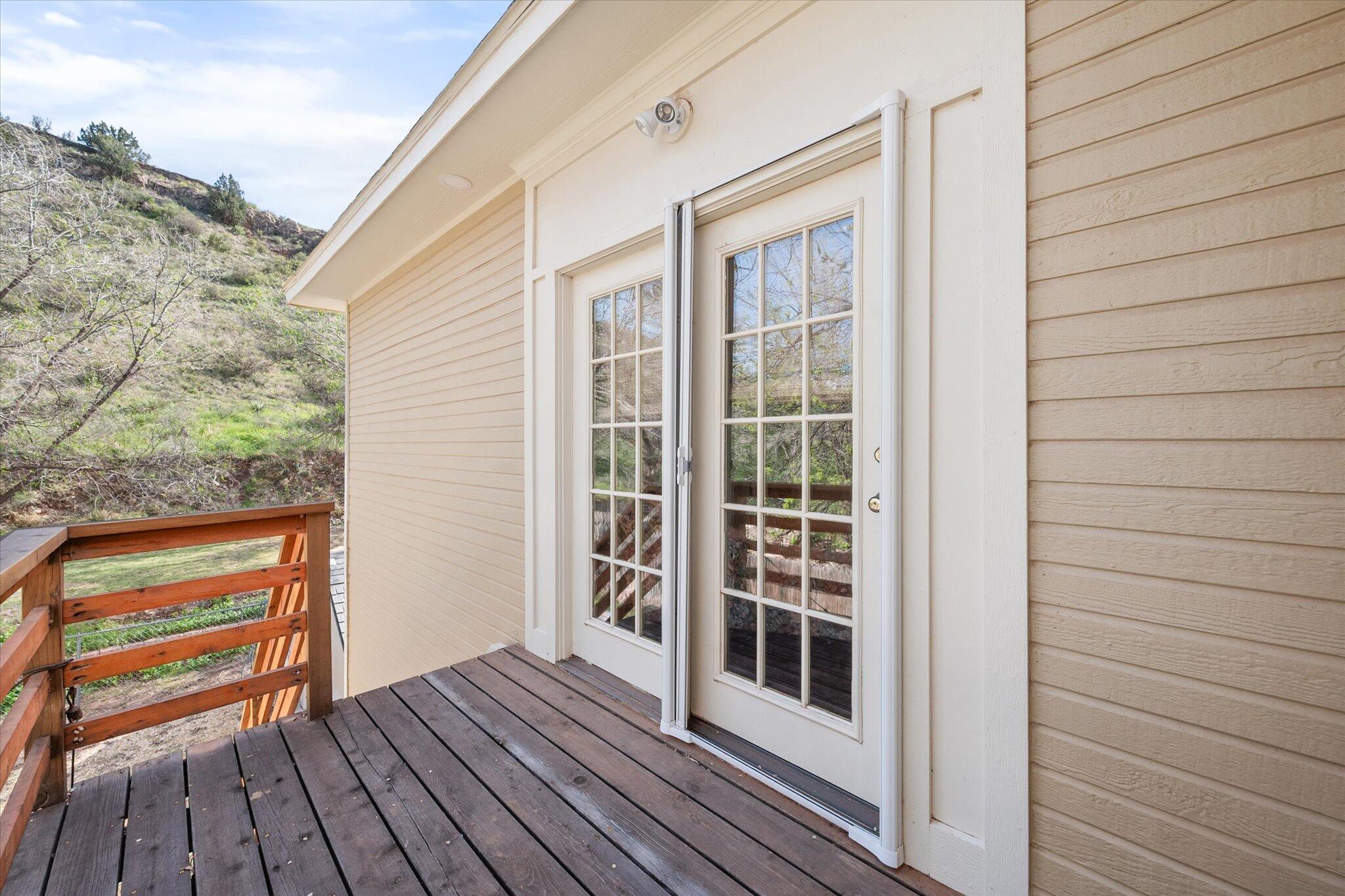 67 South Lake Shore Drive Ransom Canyon, TX 79366 - Photo 46 of 52 a view of front door deck and covered with wooden floor