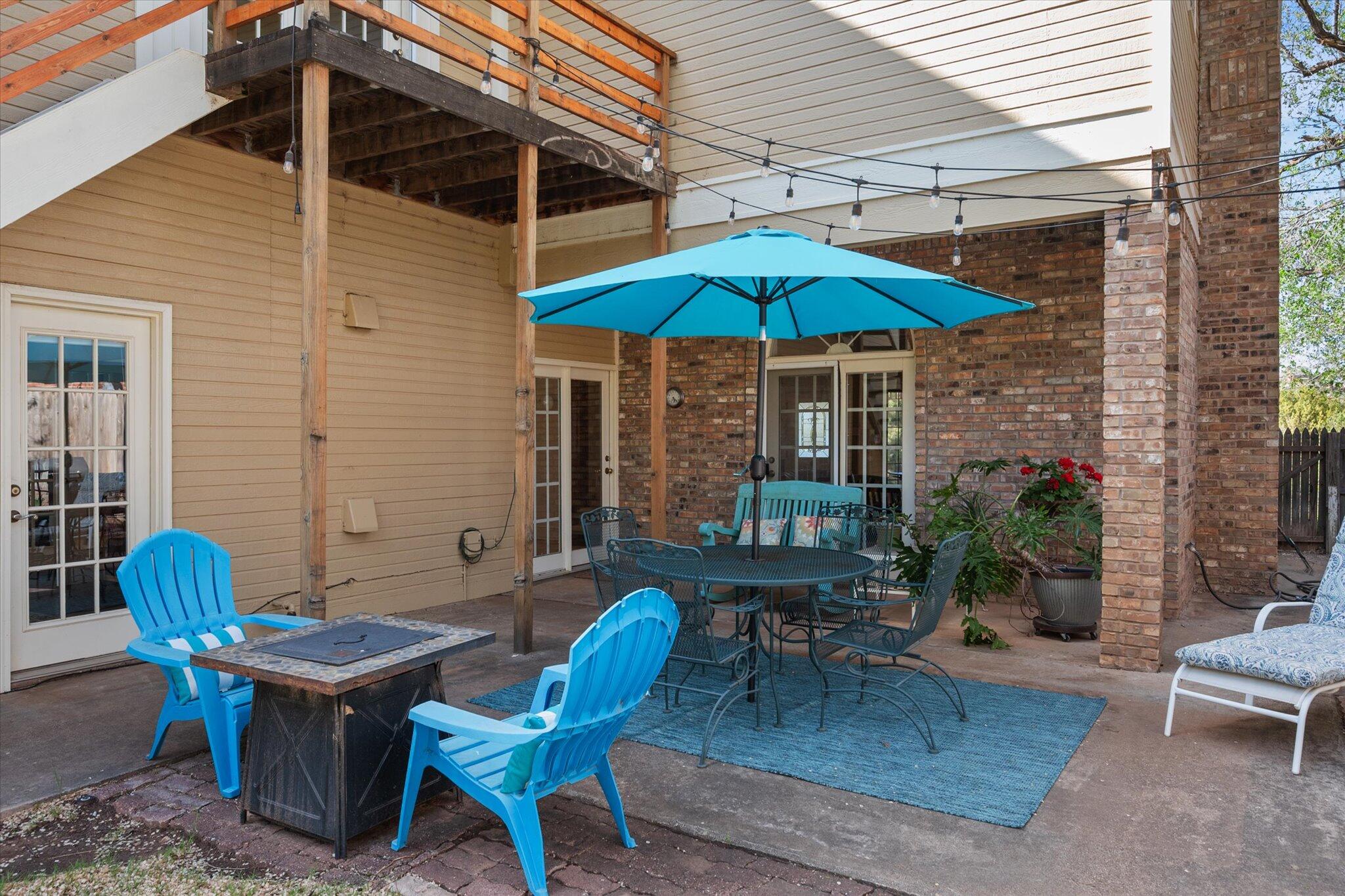 67 South Lake Shore Drive Ransom Canyon, TX 79366 - Photo 50 of 52 a patio with a table and chairs under an umbrella