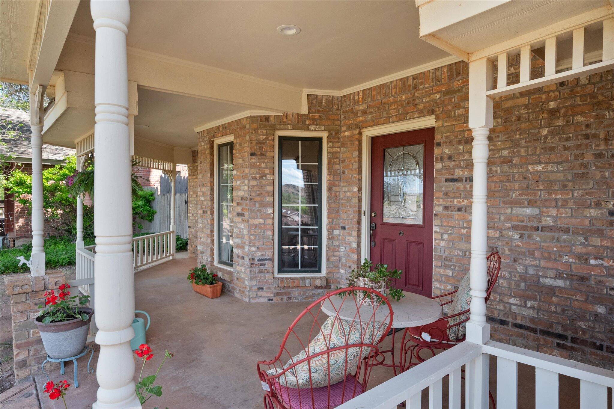 67 South Lake Shore Drive Ransom Canyon, TX 79366 - Photo 7 of 52 a view of a patio with dining table and chairs potted plants
