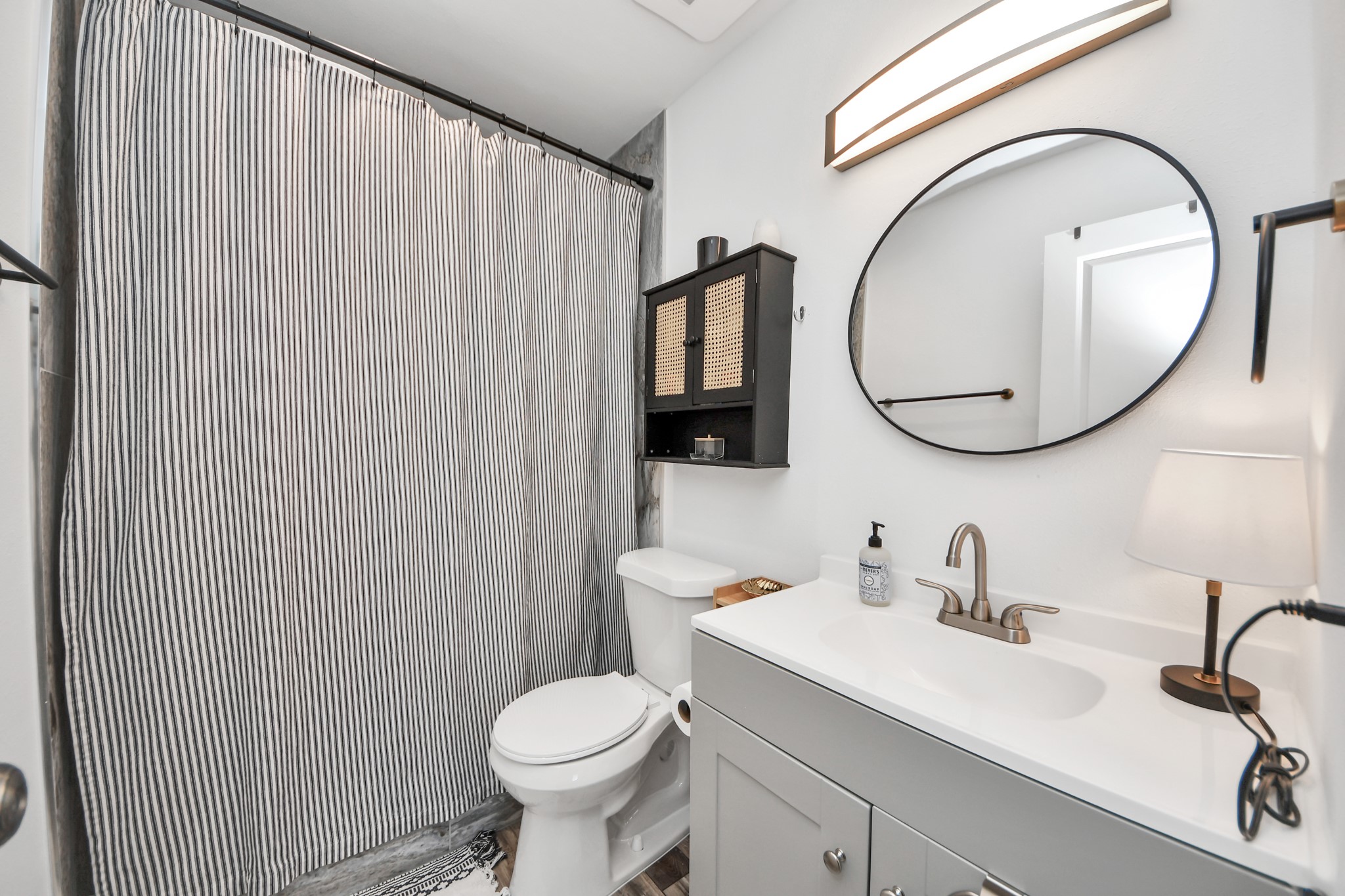 3224 Timmons Lane, Unit 168 Houston, TX 77027 - Photo 15 of 36 a bathroom with a sink a toilet and a mirror