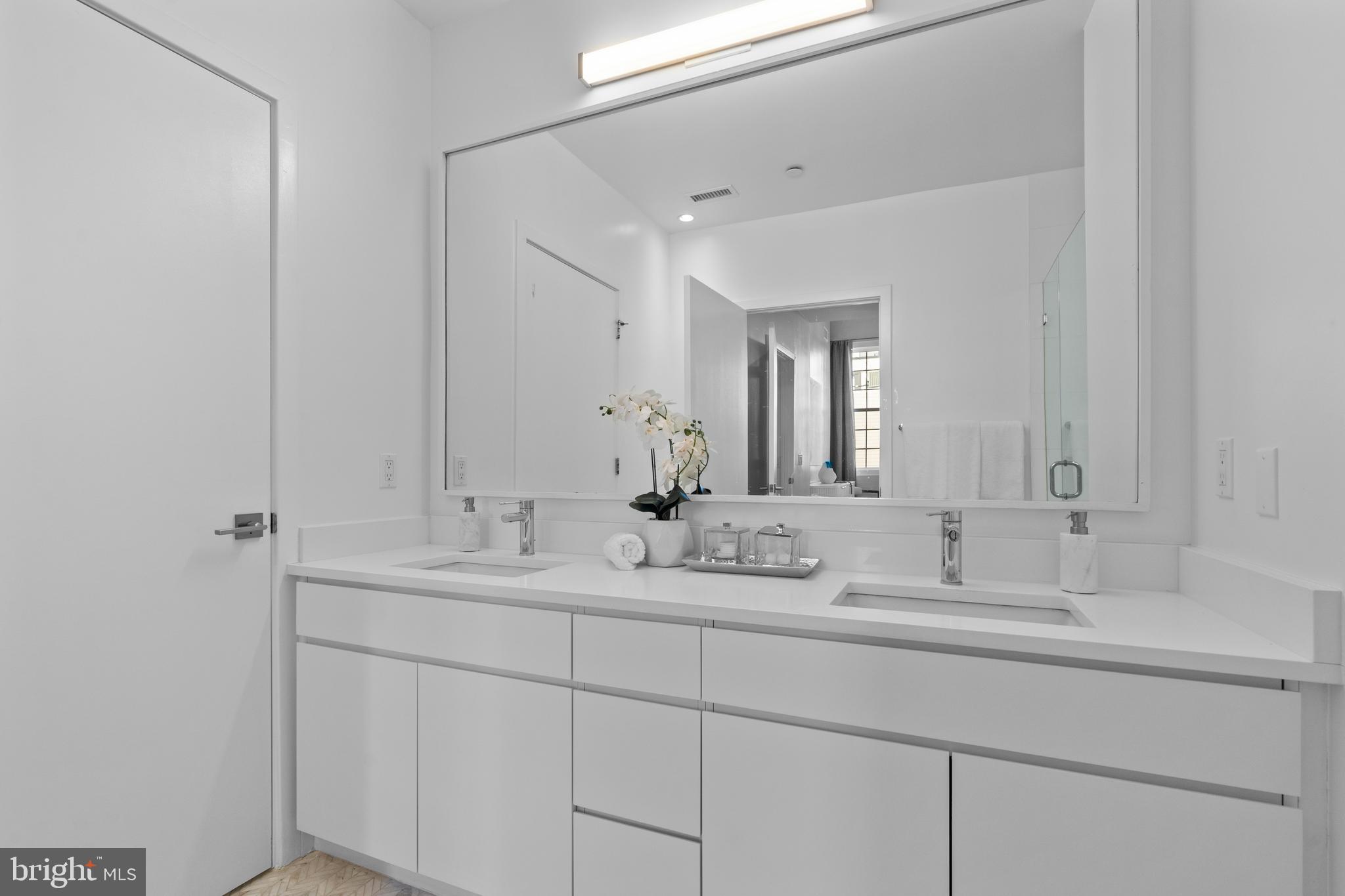 1324 E Street Southeast, Unit 201 Washington, DC 20003 - Photo 27 of 47 a bathroom with double sink and a mirror