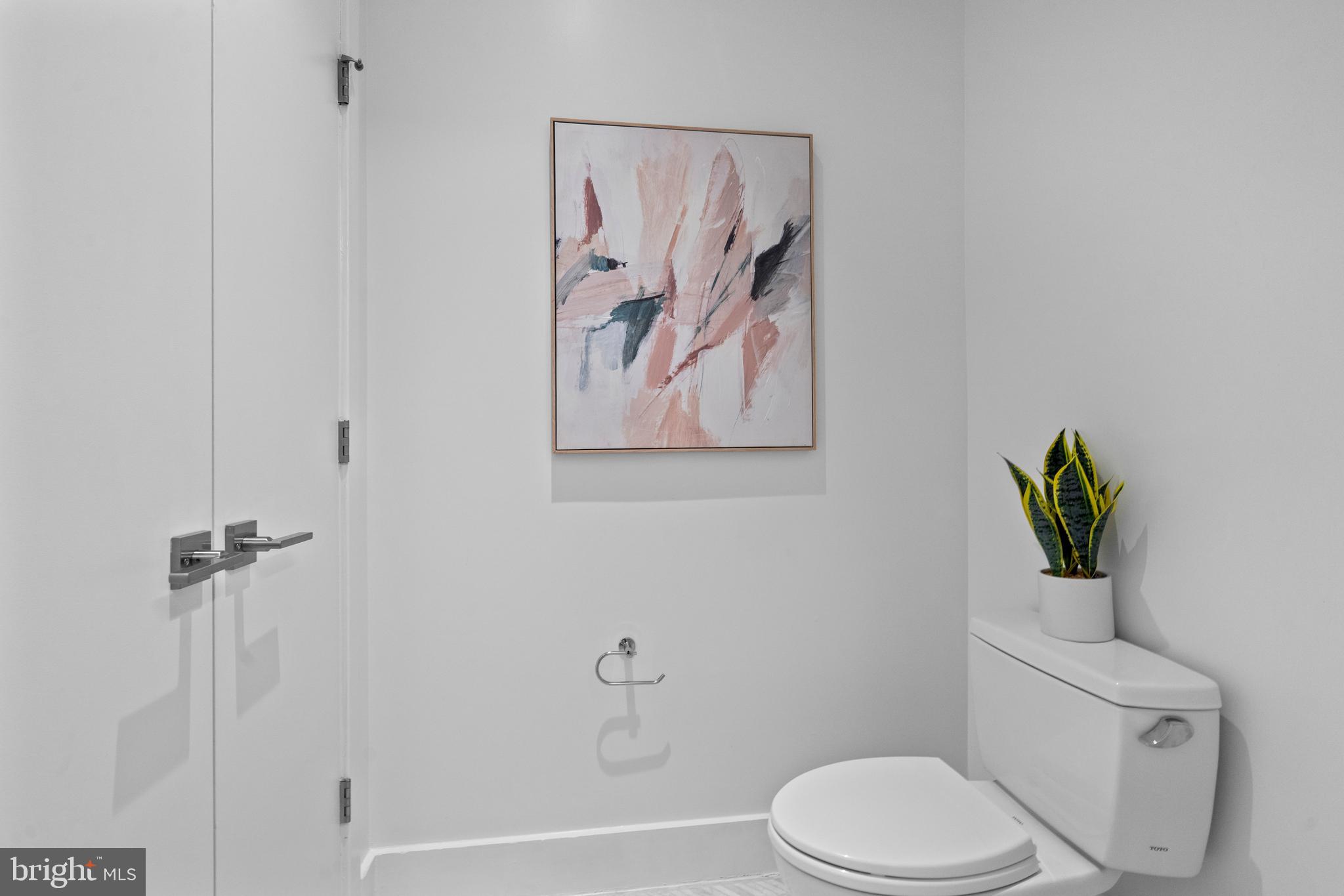 1324 E Street Southeast, Unit 201 Washington, DC 20003 - Photo 28 of 47 a white toilet sitting next to a bathroom sink