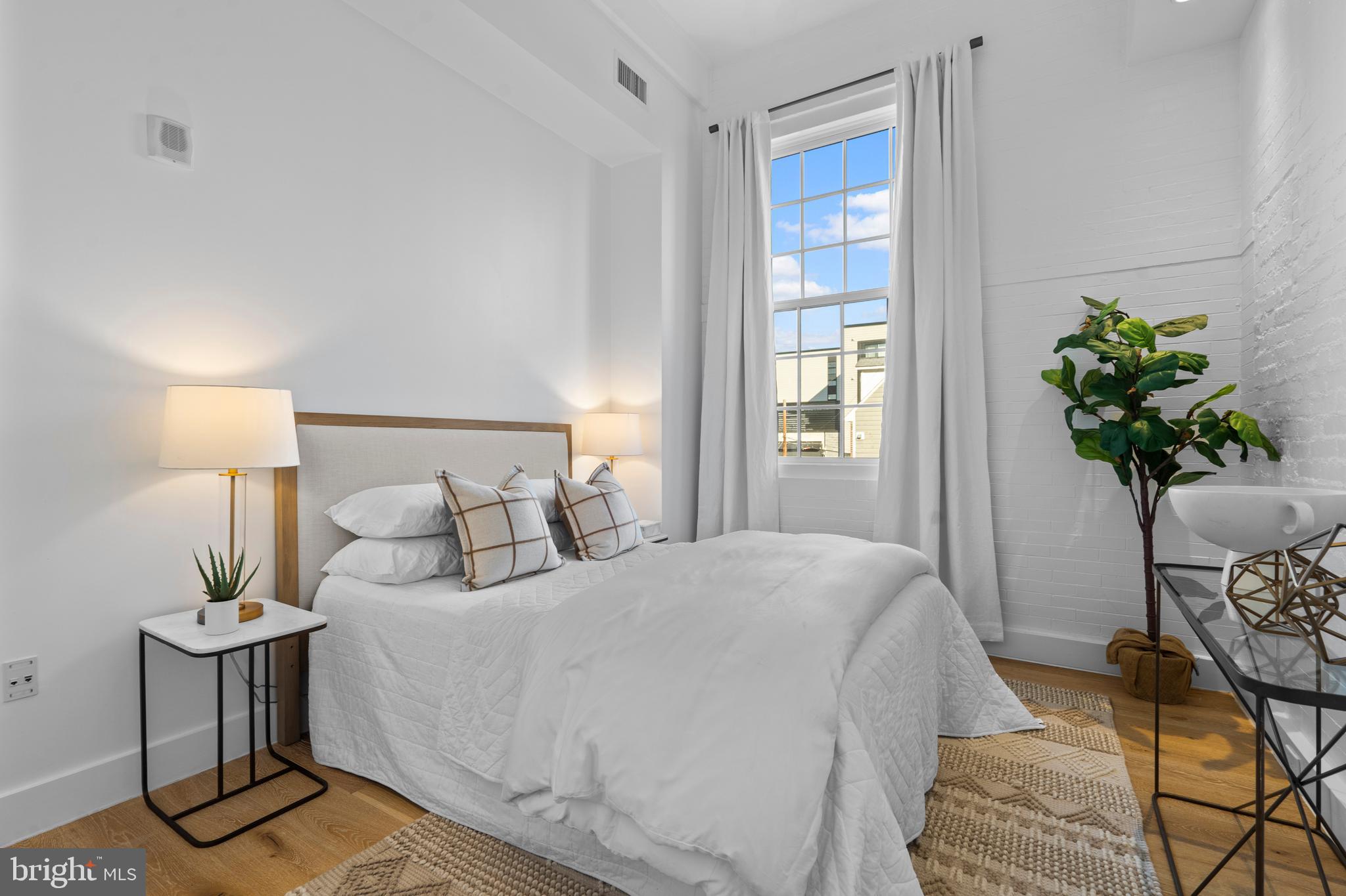 1324 E Street Southeast, Unit 201 Washington, DC 20003 - Photo 30 of 47 a bedroom with a bed potted plant and a window