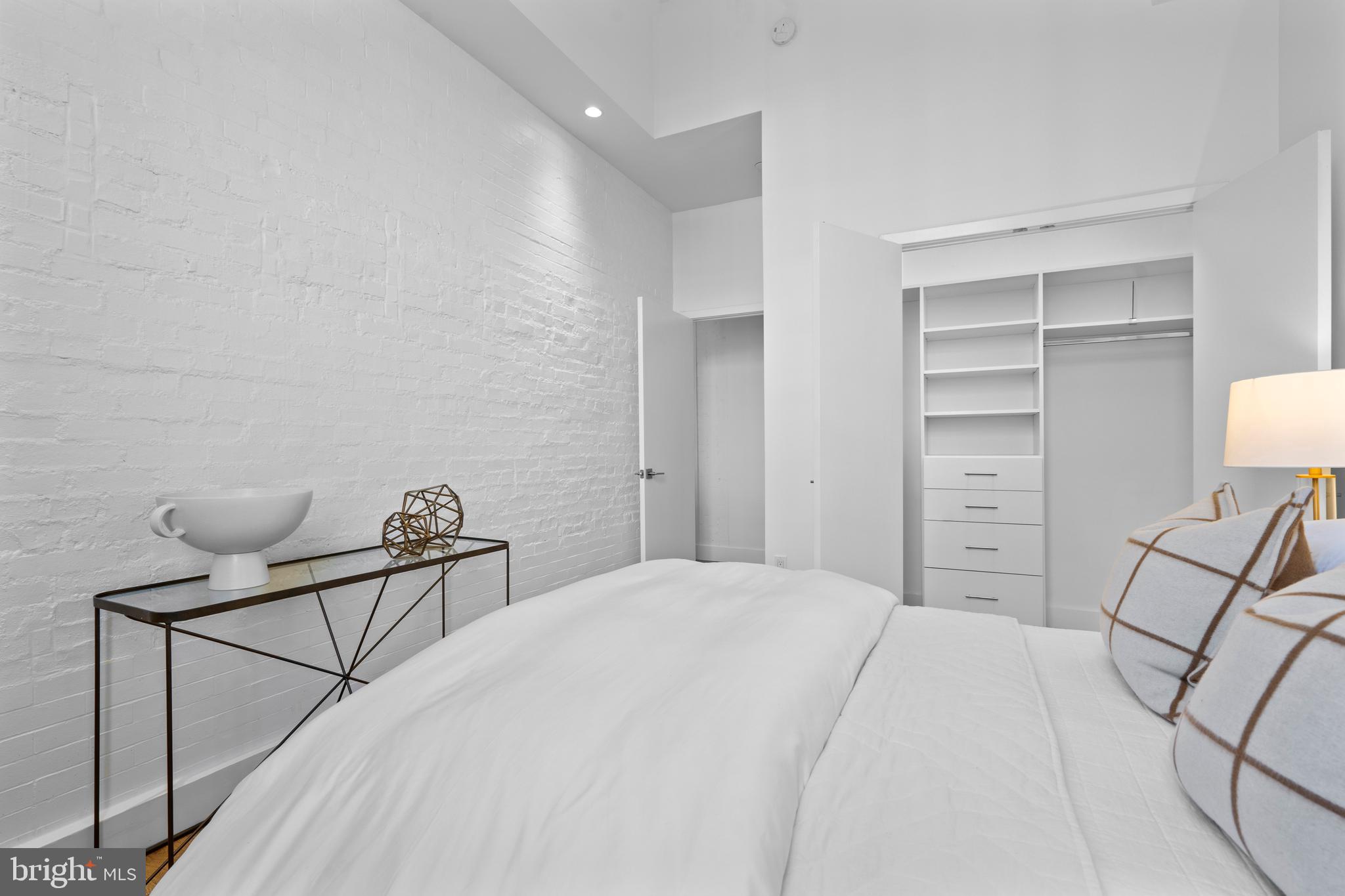 1324 E Street Southeast, Unit 201 Washington, DC 20003 - Photo 33 of 47 a bedroom with a bed and chair