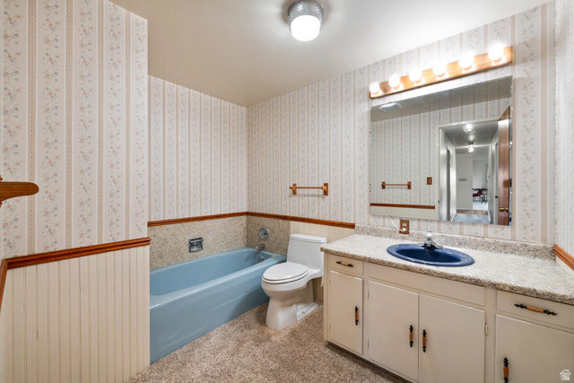 1940 West Old Hwy Road Morgan, UT 84050 - Photo 33 of 73 Full bathroom featuring a single vanity with a blue basin, a large wall-mounted mirror, a tub, and wallpapered walls with beadboard wainscoting