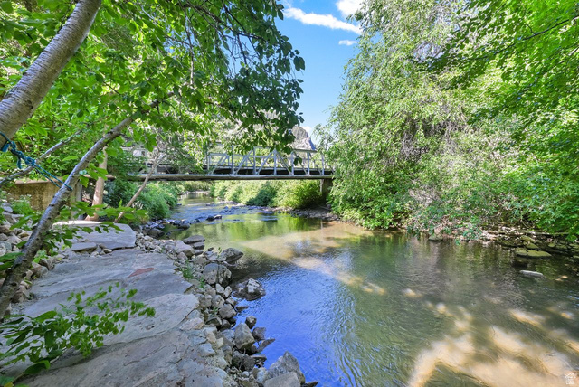 655 Ogden Canyon Road Ogden, UT 84401 - Photo 31 of 50 Riverside property featuring a tranquil stream, a footbridge, and abundant natural foliage