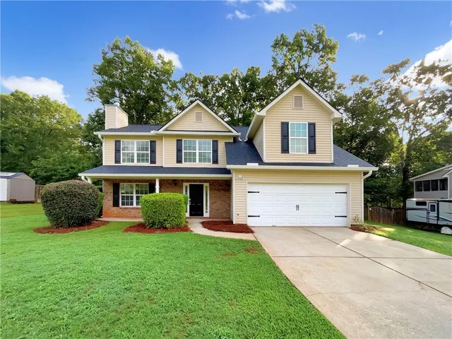 a front view of a house with garden