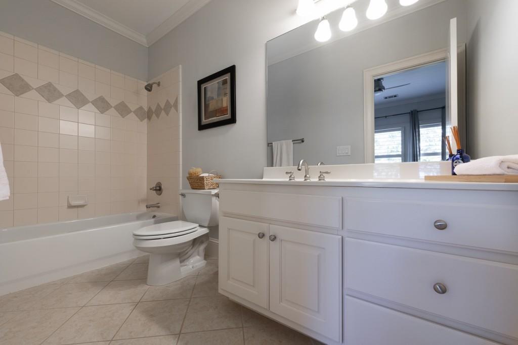 165 Autry Trail Alpharetta, GA 30022 - Photo 34 of 70 a bathroom with a toilet a sink a mirror a bathtub and vanity
