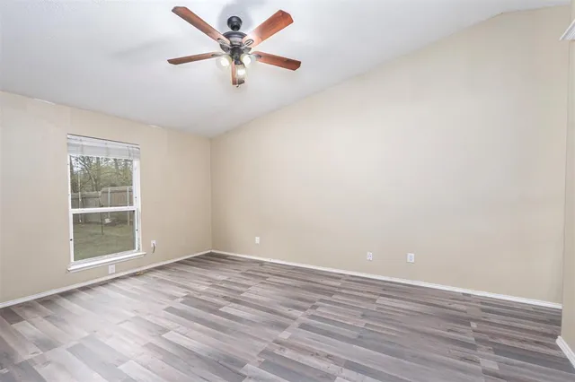 wooden floor in an empty room with a window