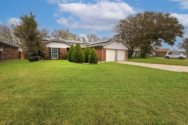 an aerial view of a house with a yard