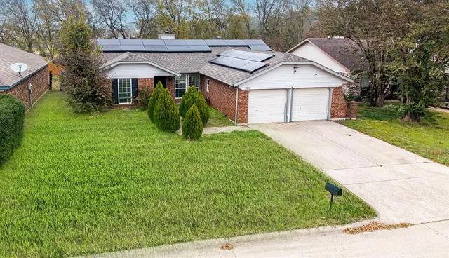 a view of swimming pool with lawn chairs and large trees