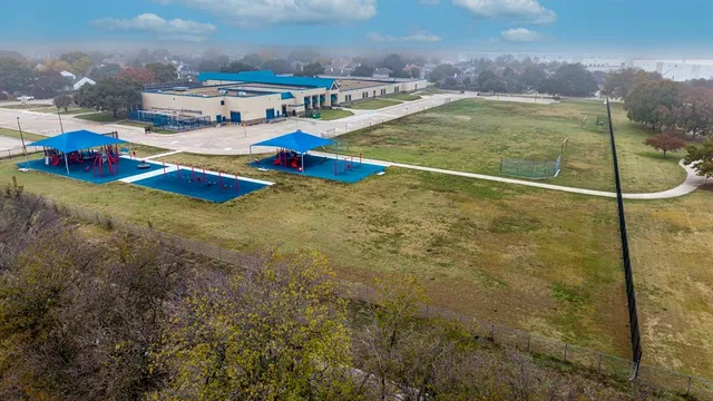 an aerial view of a house with a garden and lake view