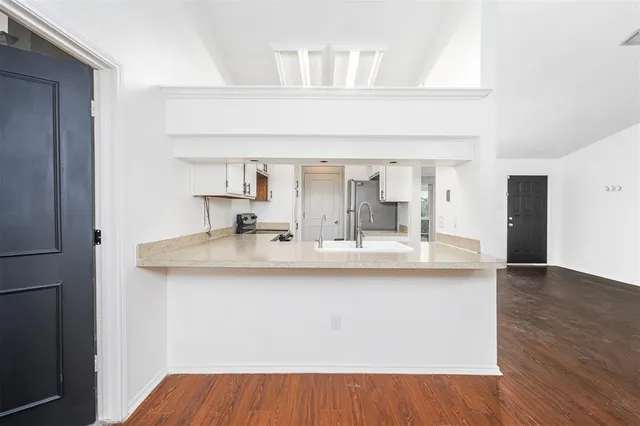 a view of kitchen with sink and wooden floor