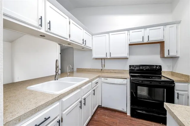 a kitchen with a sink stove and cabinets