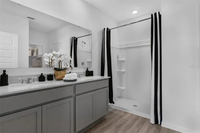 a bathroom with a double vanity sink mirror and double