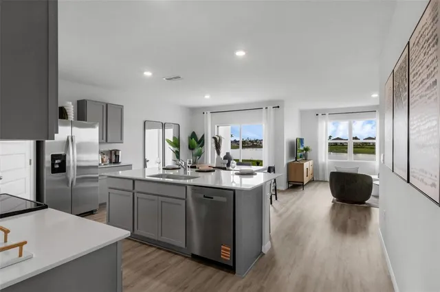 a kitchen with a sink appliances and cabinets