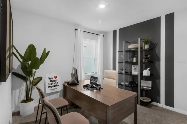 a work room with furniture and a potted plant