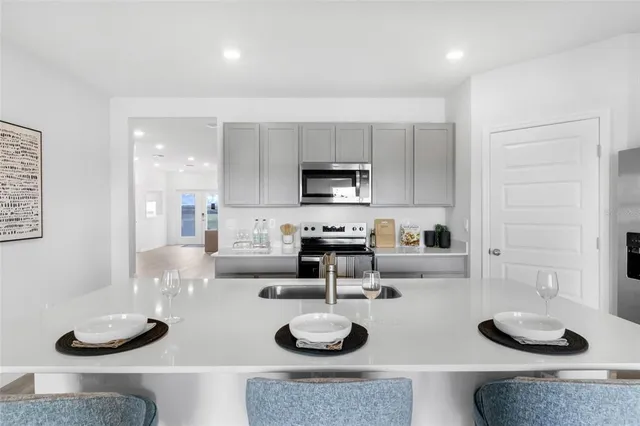 a kitchen with granite countertop cabinets and stainless steel appliances
