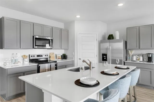 a kitchen with a dining table and chairs