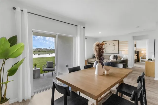 a view of a dining room with furniture and a potted plant