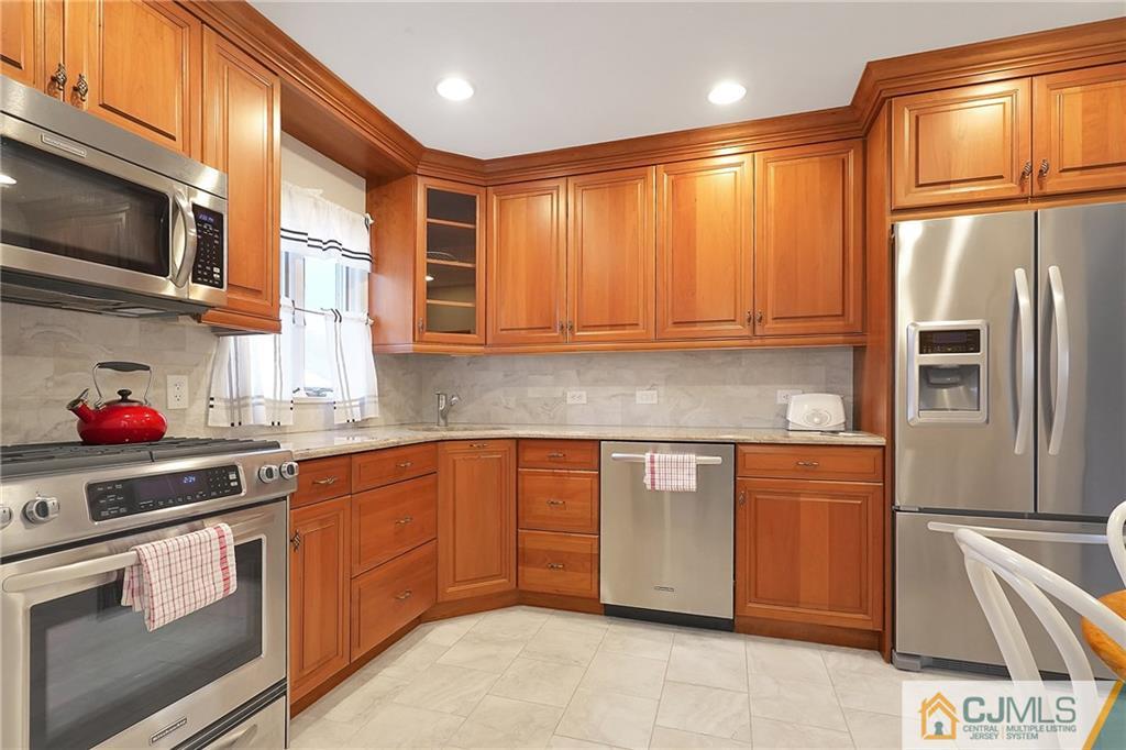 6 Meyer Road Edison, NJ 08817 - Photo 12 of 32 a kitchen with stainless steel appliances granite countertop a refrigerator and a stove top oven