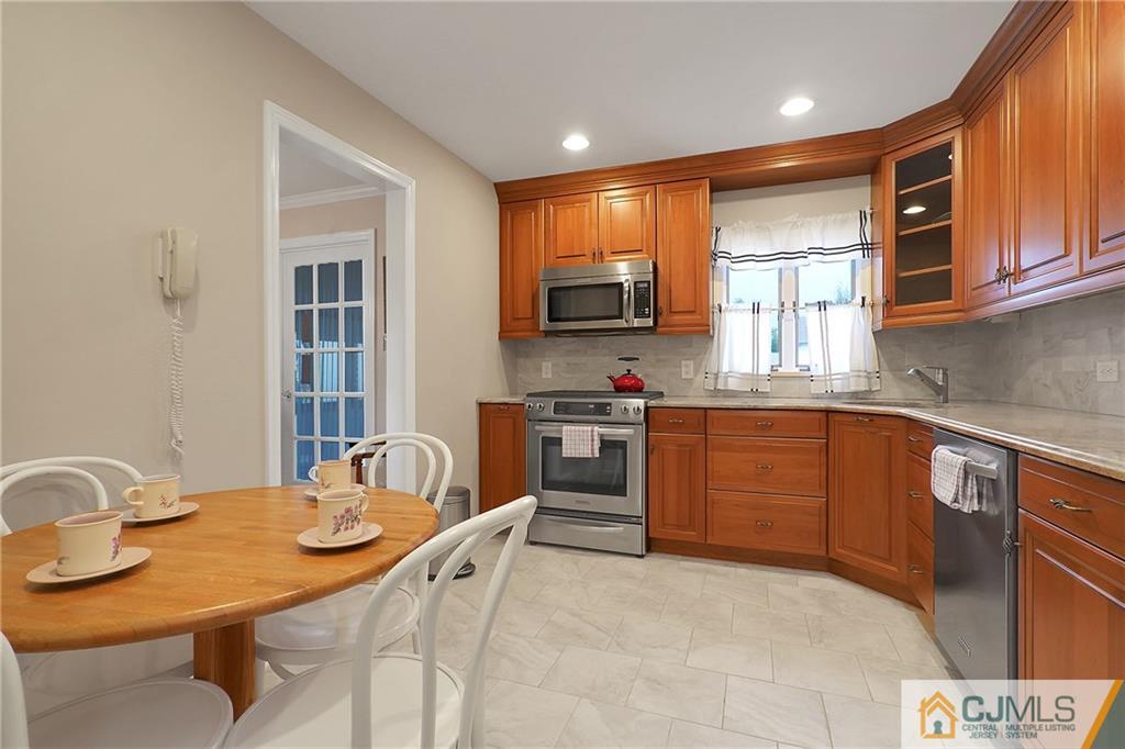6 Meyer Road Edison, NJ 08817 - Photo 13 of 32 a kitchen with stainless steel appliances kitchen island granite countertop a sink and cabinets