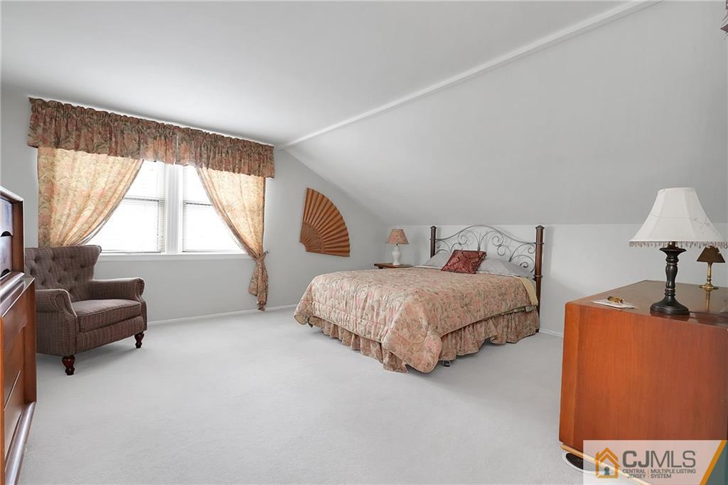 6 Meyer Road Edison, NJ 08817 - Photo 15 of 32 a bedroom with a bed and a couch
