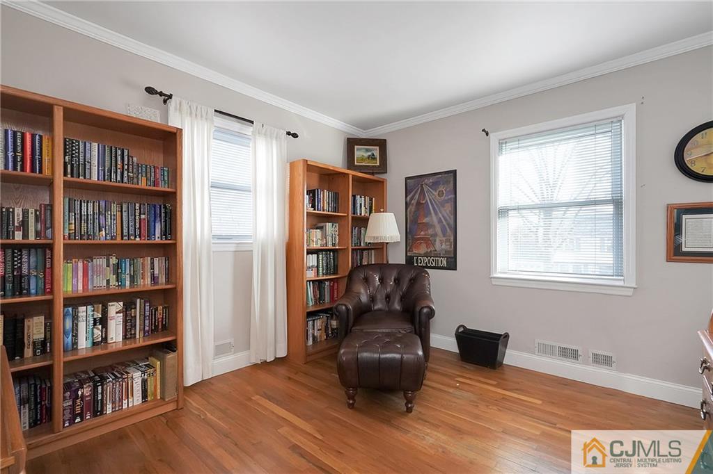 6 Meyer Road Edison, NJ 08817 - Photo 16 of 32 a living room with furniture and a book shelf